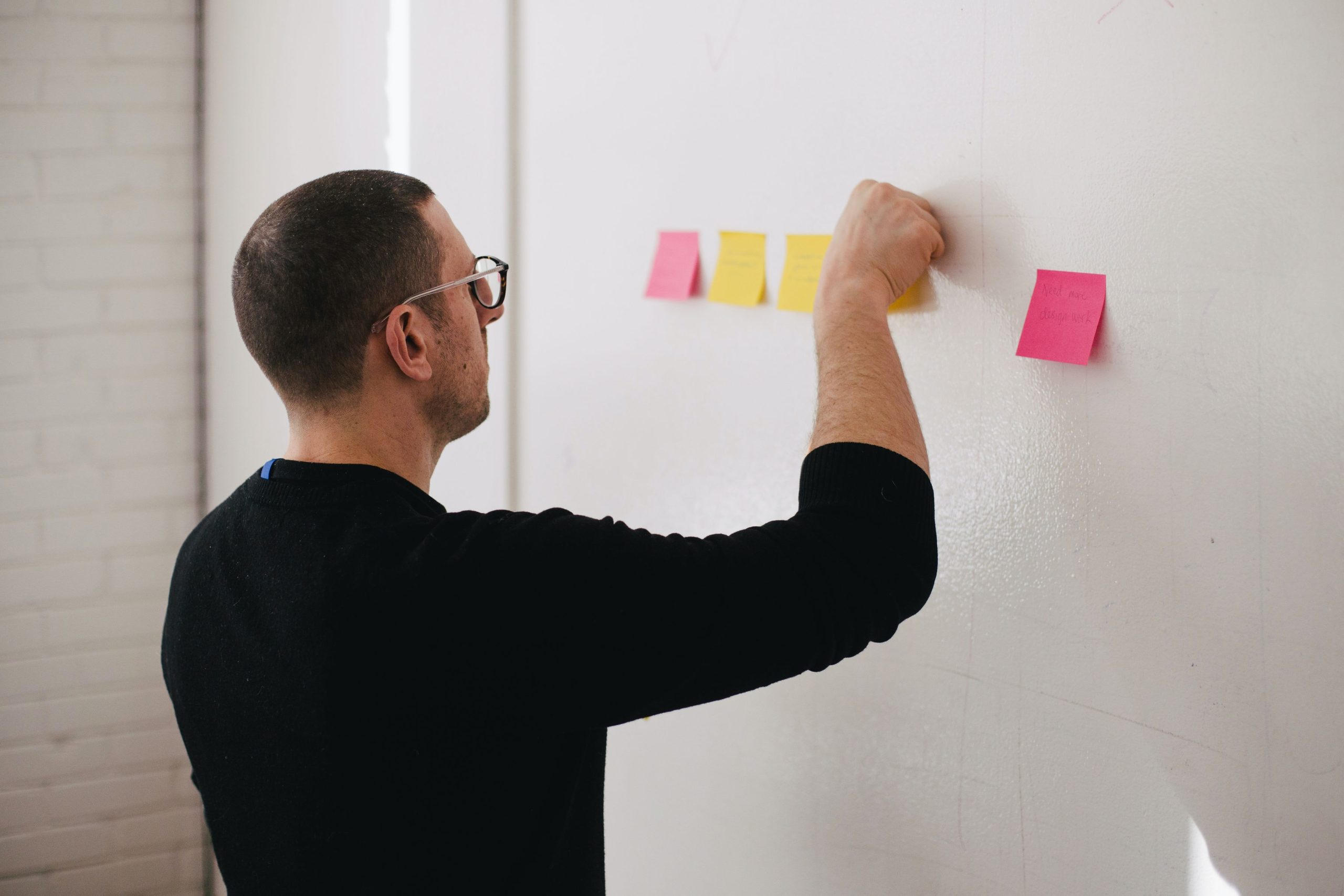 a man drawing on a white board